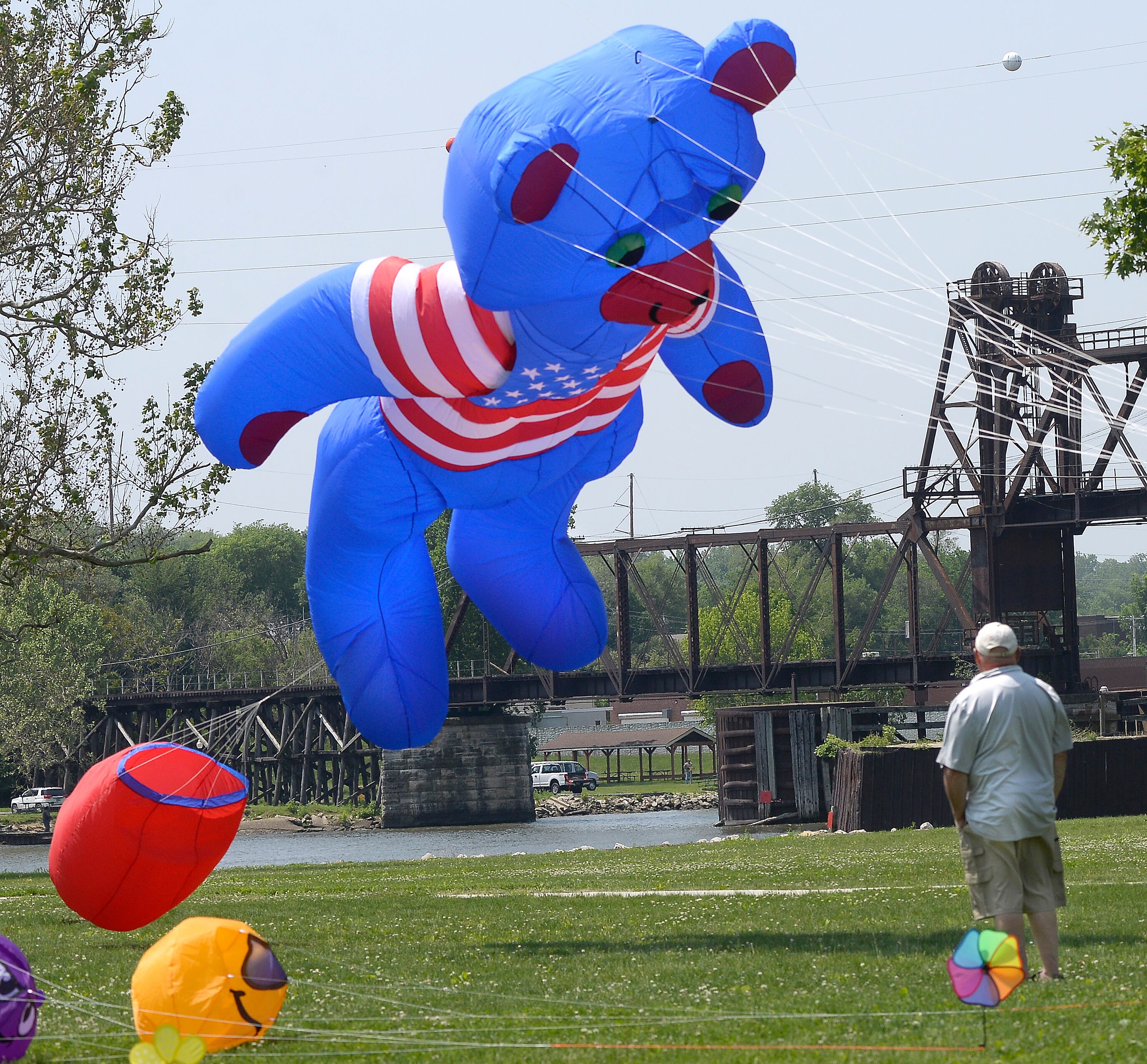 Jim Gates watches his patriotic bear take flight Saturday, May 20, 2023, during the Kites in Flight festival at Riverfront Park in Ottawa. Kite flying as well as other activities went on Saturday and Sunday.